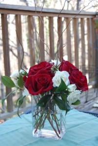 arrangement of red roses and white spray roses