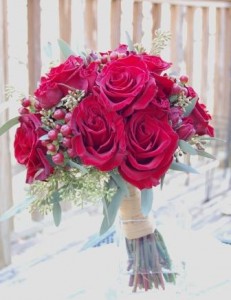 bouquet of roses, hypericum berries, and seeded euclytus