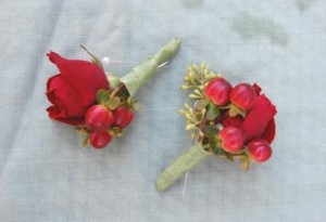 boutonniere of rose, hypericum berries, and euclytus