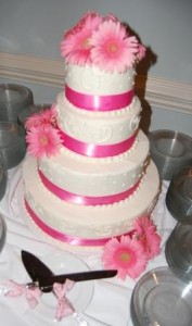 pink gerberas accent the lovely cake