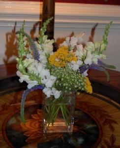 arrangement of white stock, purple veronica, queen anne's lace, and yellow freesia