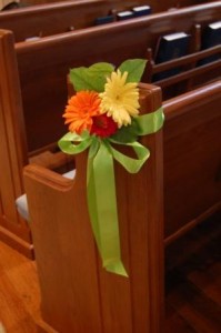 pew marker of bright gerbera daisies