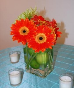 centerpiece of gerberas in a lime-filled vase