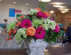 large arrangement of gerberas, roses, mums, and greenery