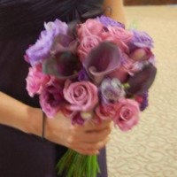 bride's bouquet of purple roses, callas, tulips, and freesia